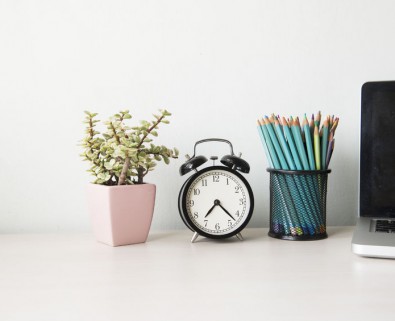 office desk with clock and plant