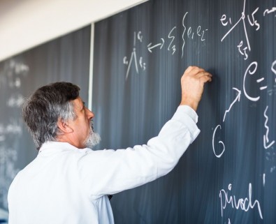 Professor drawing on chalkboard