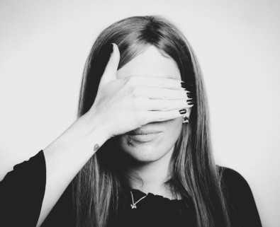 Woman covering eyes