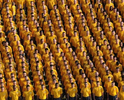 Crowd of men wearing yellow shirts
