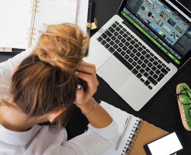 Stressed woman on laptop, workin